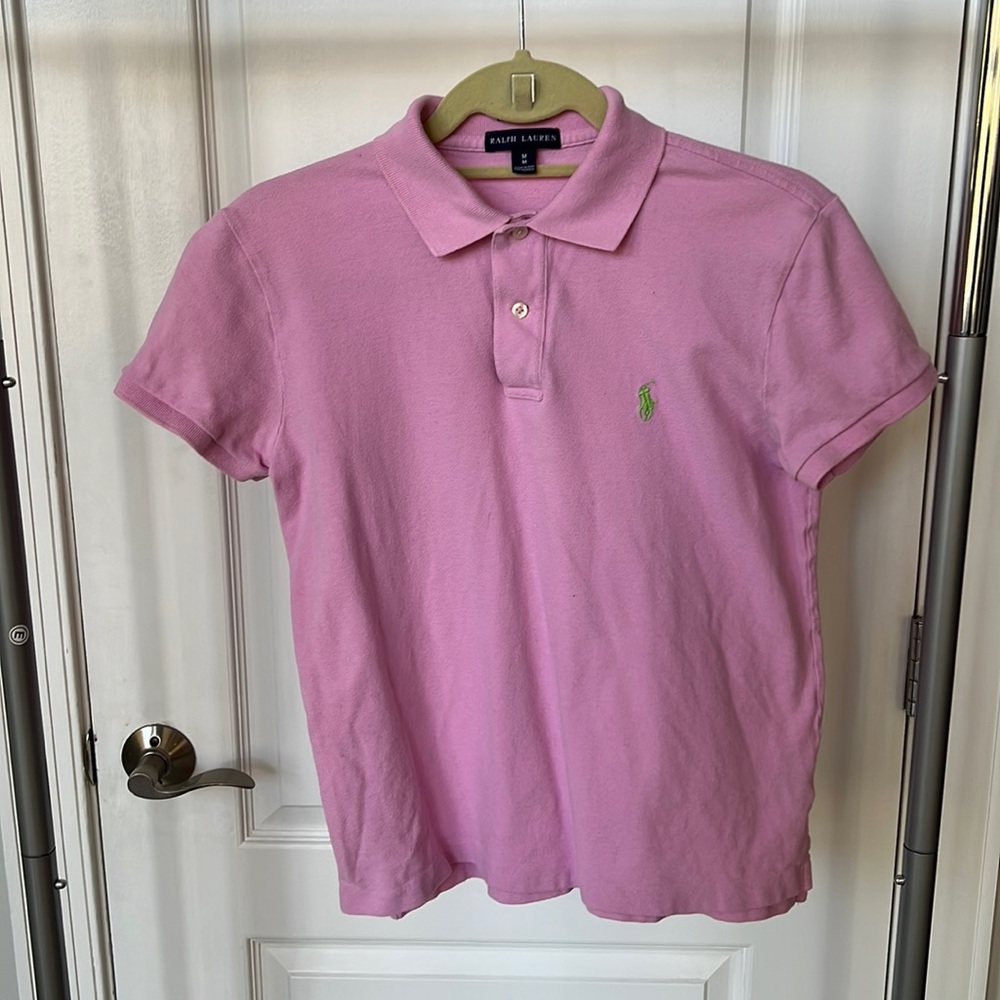 Light pink polo shirt with green embroidered logo